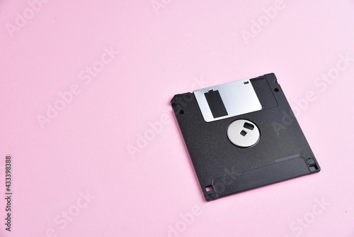 Floppy disk on pink background
