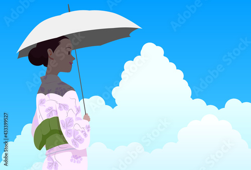 真夏の入道雲わく空の下涼しげに歩く浴衣の女性