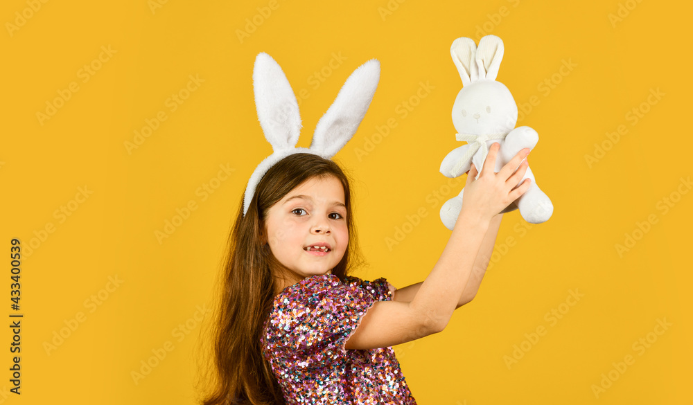 Happy easter holiday. Spring holiday preparation. Tender love. Springtime concept. Little girl hold hare toy. Happy childhood. Cute child play with toy. Toys shop. Girl in adorable funny rabbit ears Happy easter holiday. Spring holiday preparation. Tender love. Springtime concept. Little girl hold hare toy. Happy childhood. Cute child play with toy. Toys shop. Girl in adorable funny rabbit ears