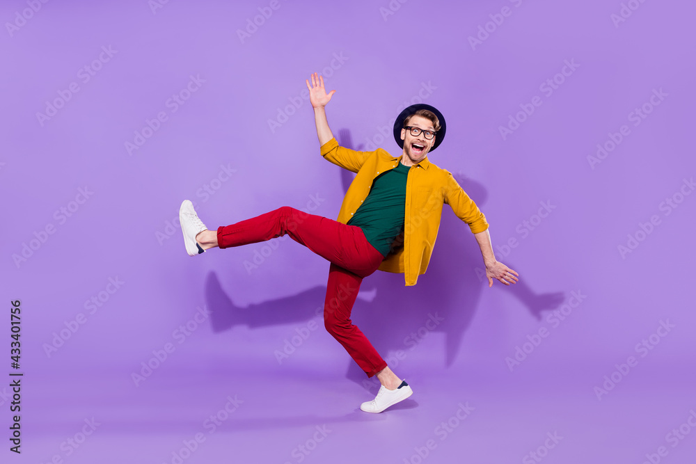 Full length body size view of attractive cheerful guy having fun fooling isolated over bright violet purple color background