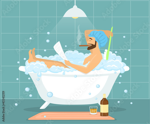 Happy funny man guy taking bath in bubble vintage bathtub, relaxing, reading newspaper, smoking cigar and drinking whiskey
