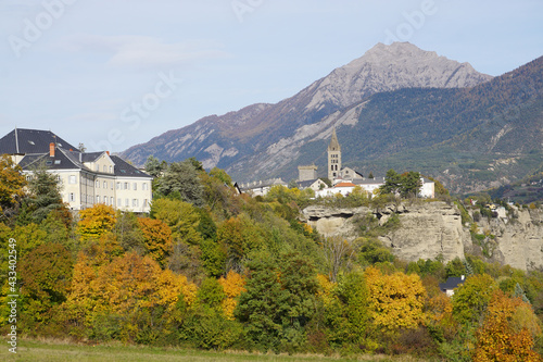 view of Embrun town on the cliff in the fall in the southern Alps, France