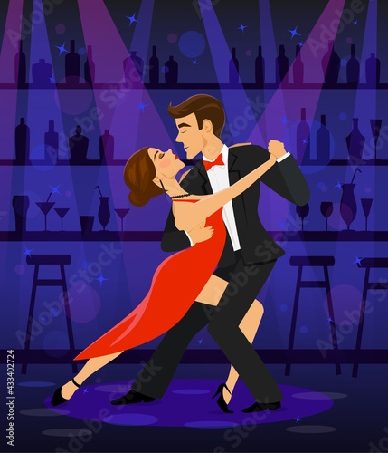 Couple dancing tango in a disco club bar under the spot lights