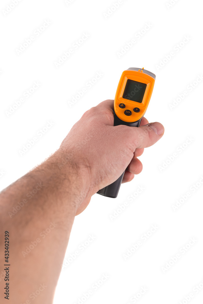 Fototapeta premium A man holds a yellow-black pyrometer. A device for non-contact temperature measurement. Studio photo of the subject isolated on white background.