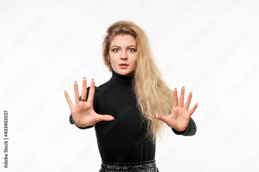 blonde girl feeling stupefied and scared, fearing something frightening, with hands open up front saying stay away blonde girl feeling stupefied and scared, fearing something frightening, with hands open up front saying stay away