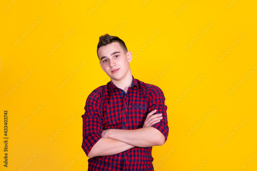 A handsome guy in a red shirt on a yellow background A handsome guy in a red shirt on a yellow background