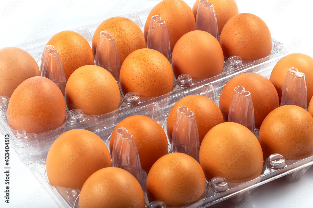Overhead view of brown chicken eggs in an open egg box isolated on white background. Fresh chicken eggs. Natural healthy food and organic farming concept. Eggs in box. Overhead view of brown chicken eggs in an open egg box isolated on white background. Fresh chicken eggs. Natural healthy food and organic farming concept. Eggs in box.