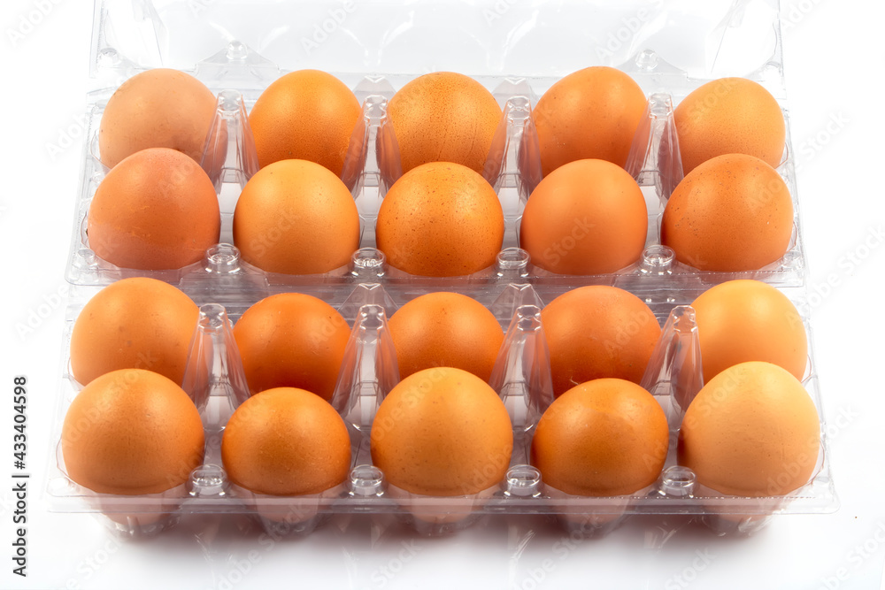 Overhead view of brown chicken eggs in an open egg box isolated on white background. Fresh chicken eggs. Natural healthy food and organic farming concept. Eggs in box. Overhead view of brown chicken eggs in an open egg box isolated on white background. Fresh chicken eggs. Natural healthy food and organic farming concept. Eggs in box.