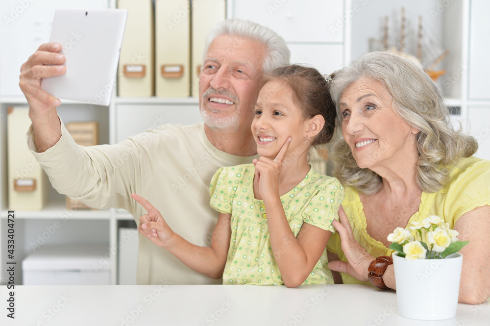 Grandparents with her granddaughter taking selfie Grandparents with her granddaughter taking selfie