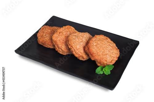 Minced pork deep fried, Meatballs mixed with salt, pepper, garlic and spices, Decorated with mint leaf in black plate Japanese style, Fast food, Processed meat seasoned, Isolated on white background.