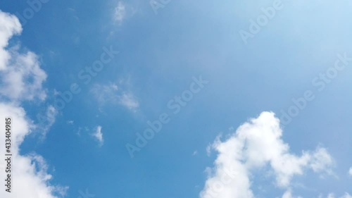 Time Lapse of beautiful sunny blue sky background with white fluffy clouds and cirrus cloudscape skyline motion on bright daylight horizon and sun ray in beautiful tropical summer season 