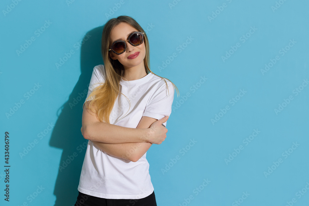 Cute Woman Is Holding Arms Crossed And Looking Aside. Cute Woman Is Holding Arms Crossed And Looking Aside.