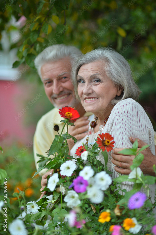 smiling senior couple posing in park smiling senior couple posing in park