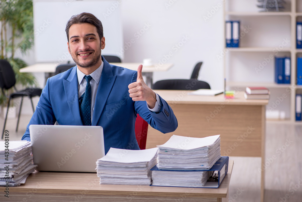 Young businessman employee and too much work in the office Young businessman employee and too much work in the office
