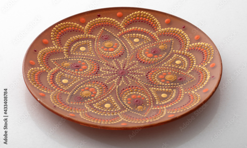 Yellow decorative plate with a mandala pattern