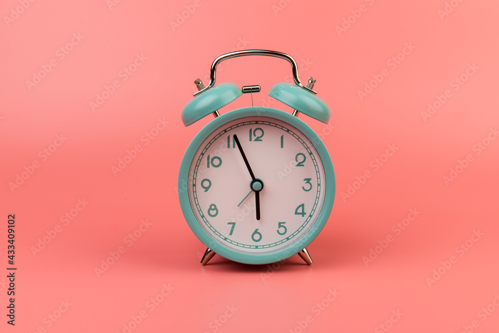 Old clock isolated on a pink background with space for text. Concept of time Old clock isolated on a pink background with space for text. Concept of time