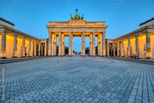 The illuminated Brandenburg Gate in Berlin at dawn photo