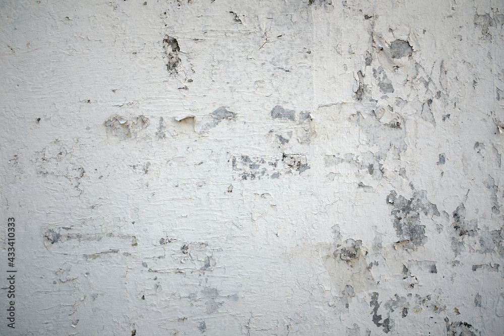 Fototapeta premium white concrete surface and white paint peeling from the wall, for use as a background.