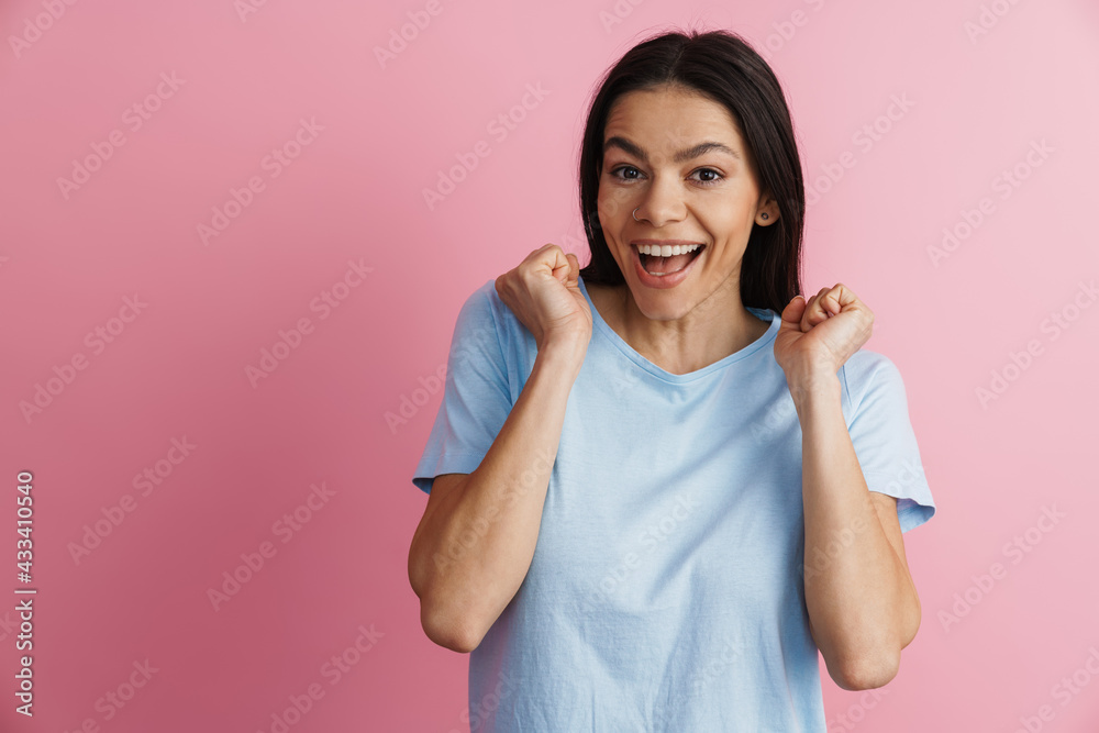 Excited hispanic woman gesturing and laughing at camera