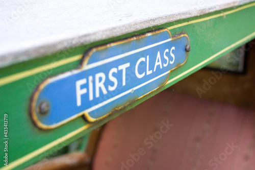 Close up of a first-class sign on a miniature railway carriage
