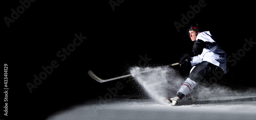 ice hockey player in action kicking with stick