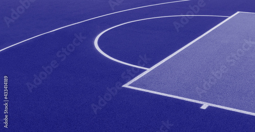 Abstract  blue background of newly made outdoor basketball court. Visible asphalt texture  freshly painted lines. Blue color filter