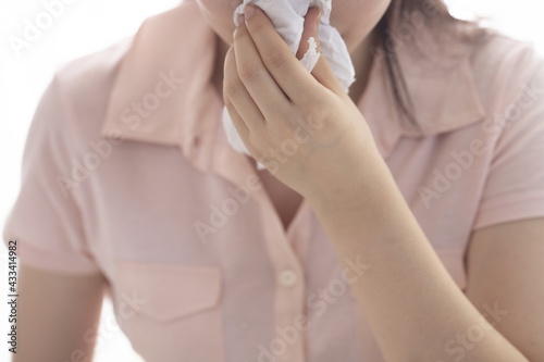 Woman blowing nose. Health and medicine concept.