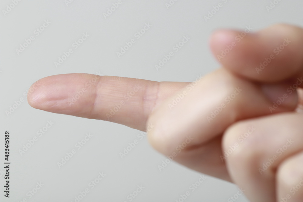 Close-Up Of Cropped Hand Pointing Finger Close-Up Of Cropped Hand Pointing Finger