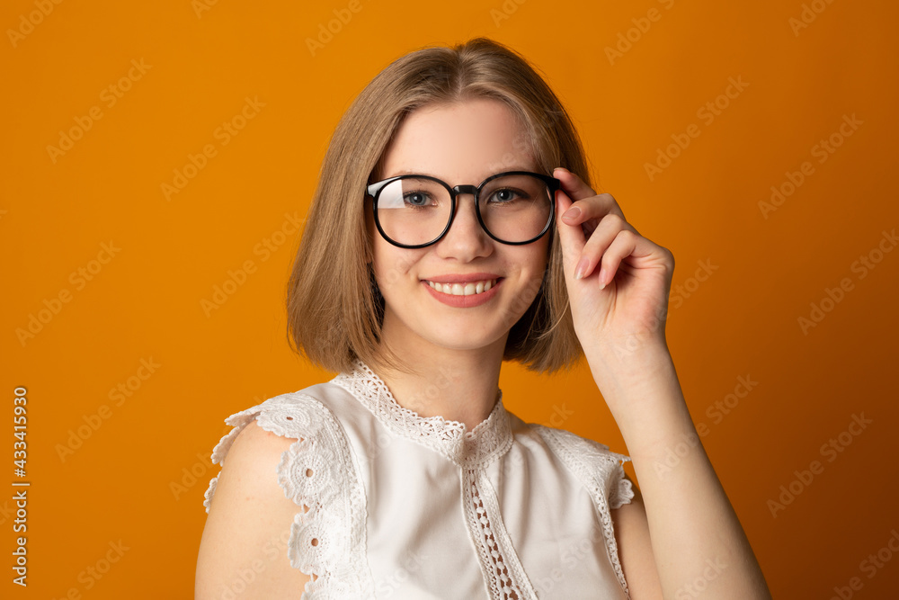 portrait of a beautiful young woman wearing glasses on a yellow background portrait of a beautiful young woman wearing glasses on a yellow background
