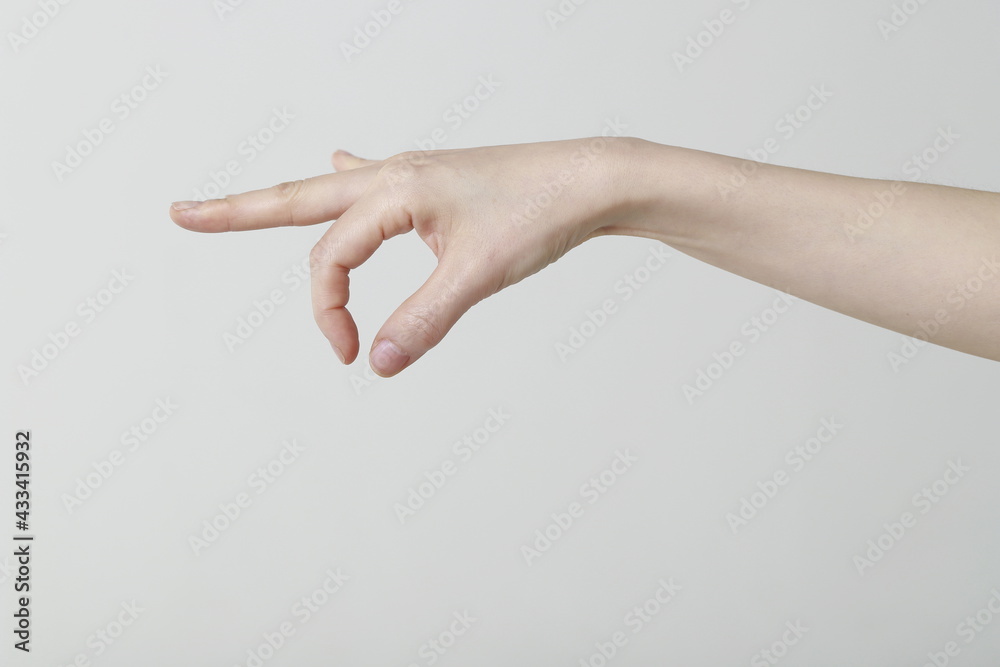Cropped image of woman hand picking up something Cropped image of woman hand picking up something
