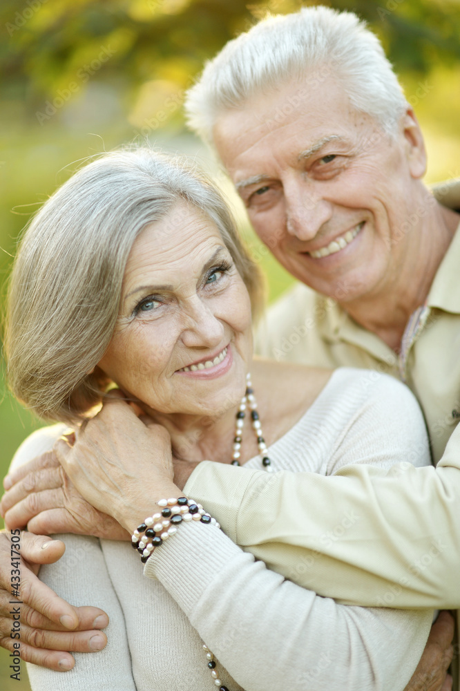 smiling senior couple embracing in autumn park smiling senior couple embracing in autumn park