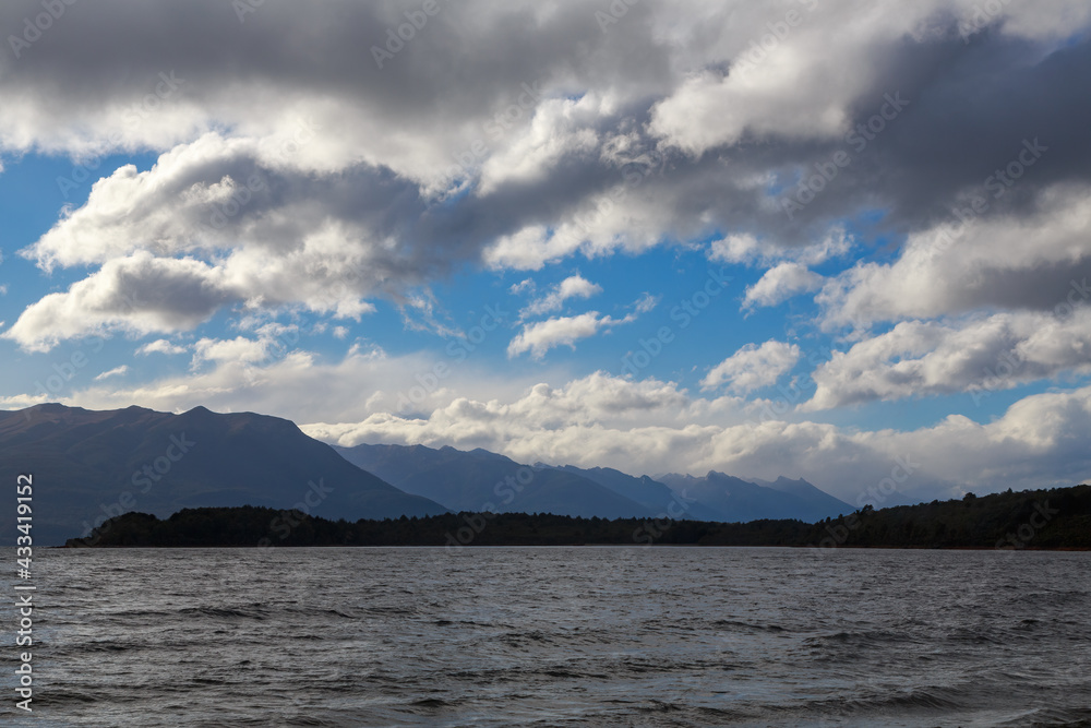 A sky full of fluffy clouds above Lake Te Anau, the largest lake in the South Island of New Zealand