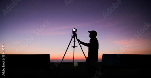 Photography Silhouette of the photographer with tripod