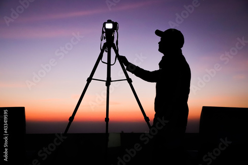 Photography Silhouette of the photographer with tripod