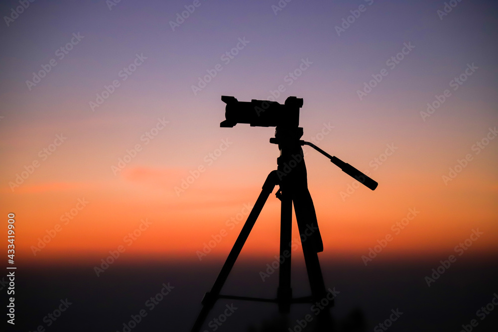 Silhouette of a camera on the tripod