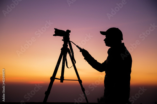Photography Silhouette of the photographer with tripod