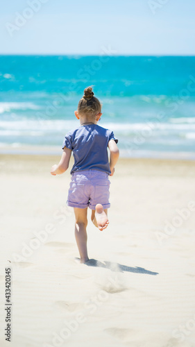 Little girl runs along the sandy seashore © SEA_Ekaterina