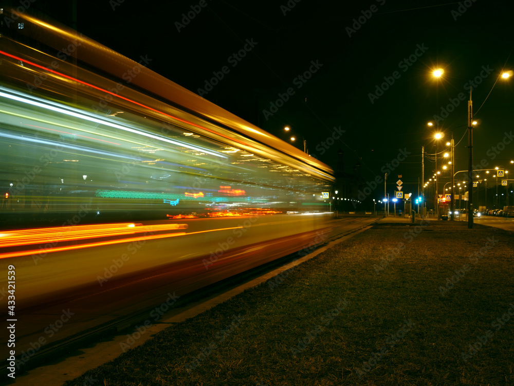 night tram red light trails motion blur passing by