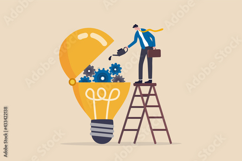 Maintenance brain to generate idea or creativity and innovation to invent new business ideas concept, businessman drop lubricant or grease into open lightbulb lamp with mechanical gears.