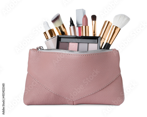 Different luxury decorative cosmetics and brushes in pink case on white background
