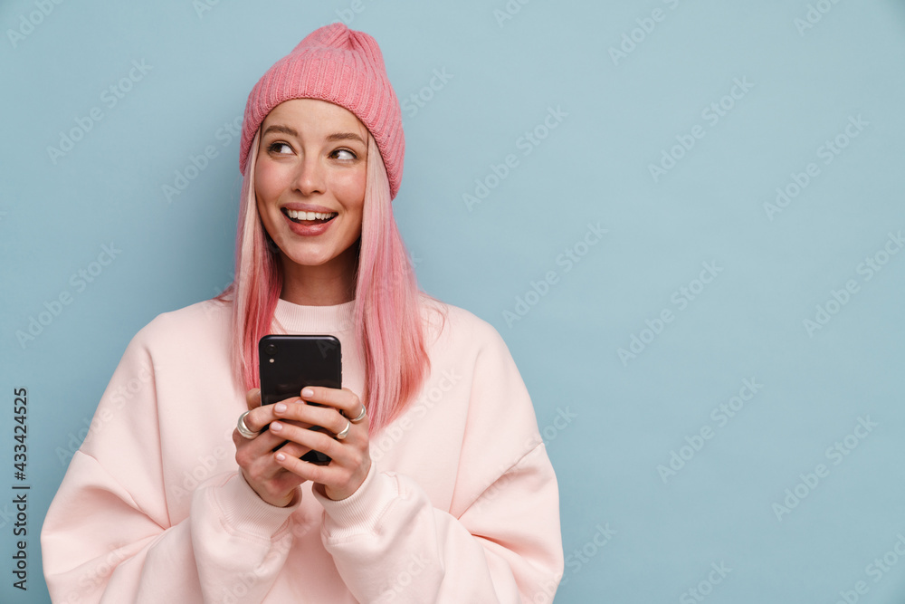 Young white woman smiling while using mobile phone Young white woman smiling while using mobile phone