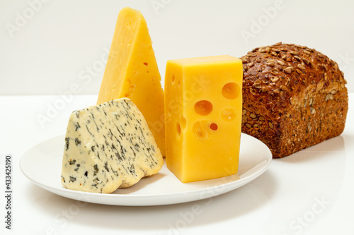 Fourme d'Ambert, cheese hit fitness on plate and loaf of rye bread photo
