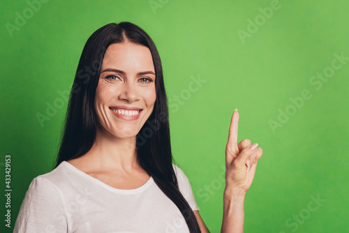 Beautiful young woman showing emptyspace with fingers