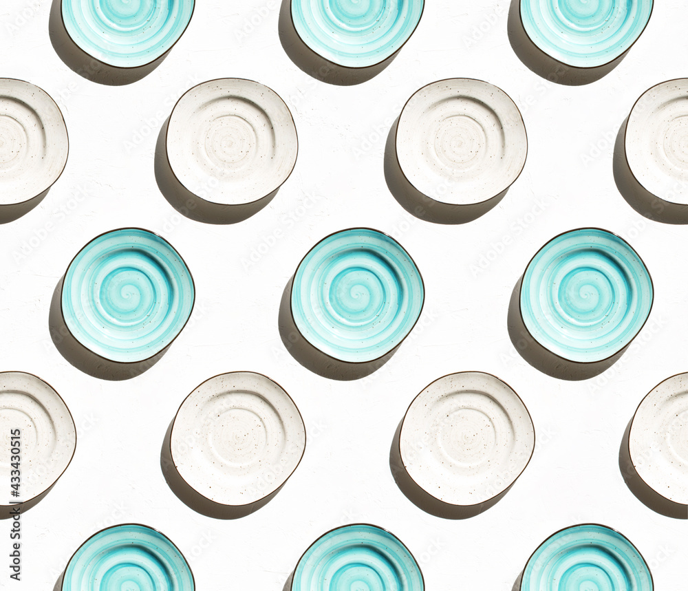 Seamless pattern with porcelain aquamarine and light beige plates on a white textured background. Seamless pattern with porcelain aquamarine and light beige plates on a white textured background.
