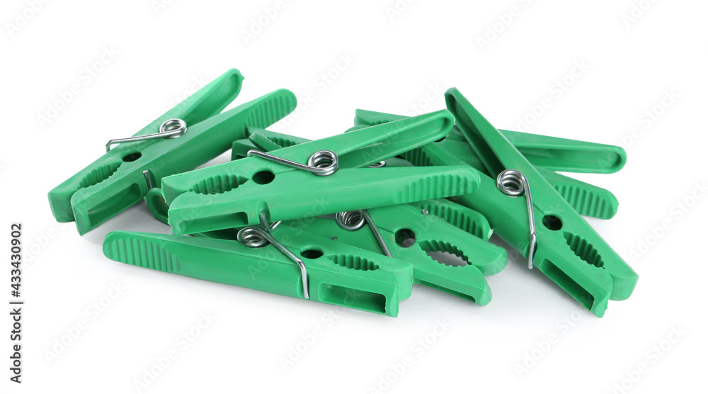 Bright green plastic clothespins on white background Bright green plastic clothespins on white background