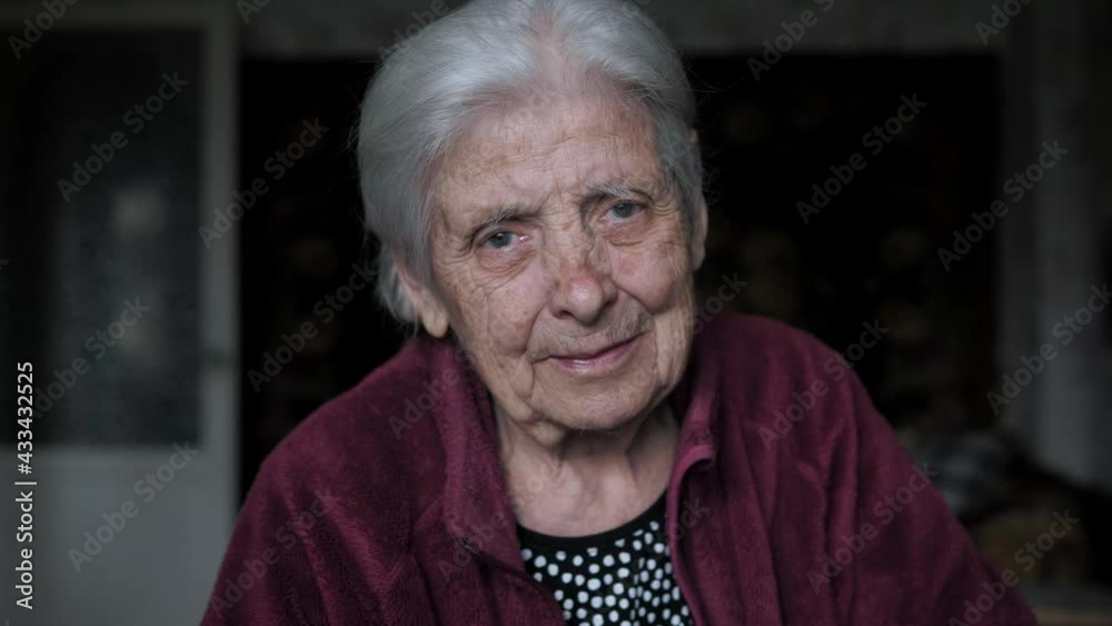 Portrait Of Old Woman With Tremor Nervous Tic Looking At Camera Sitting At Home Portrait Of Old Woman With Tremor Nervous Tic Looking At Camera Sitting At Home