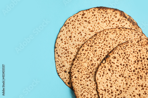 Bilde på lerret Tasty matzos on light blue background, flat lay with space for text