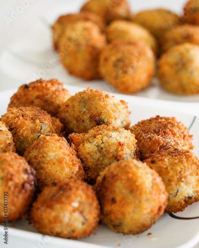 Closeup of a plate of arancini (Italian rice balls) with varying depths of focus