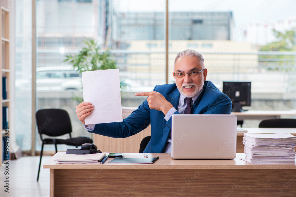 Old male boss employee working in the office Old male boss employee working in the office
