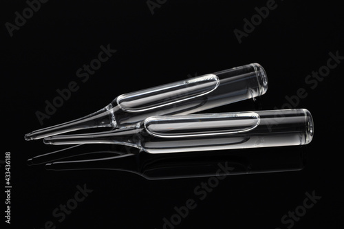 Medical ampoules for injection on dark background. Medicines and disease treatment, pharmacology and science concepts
